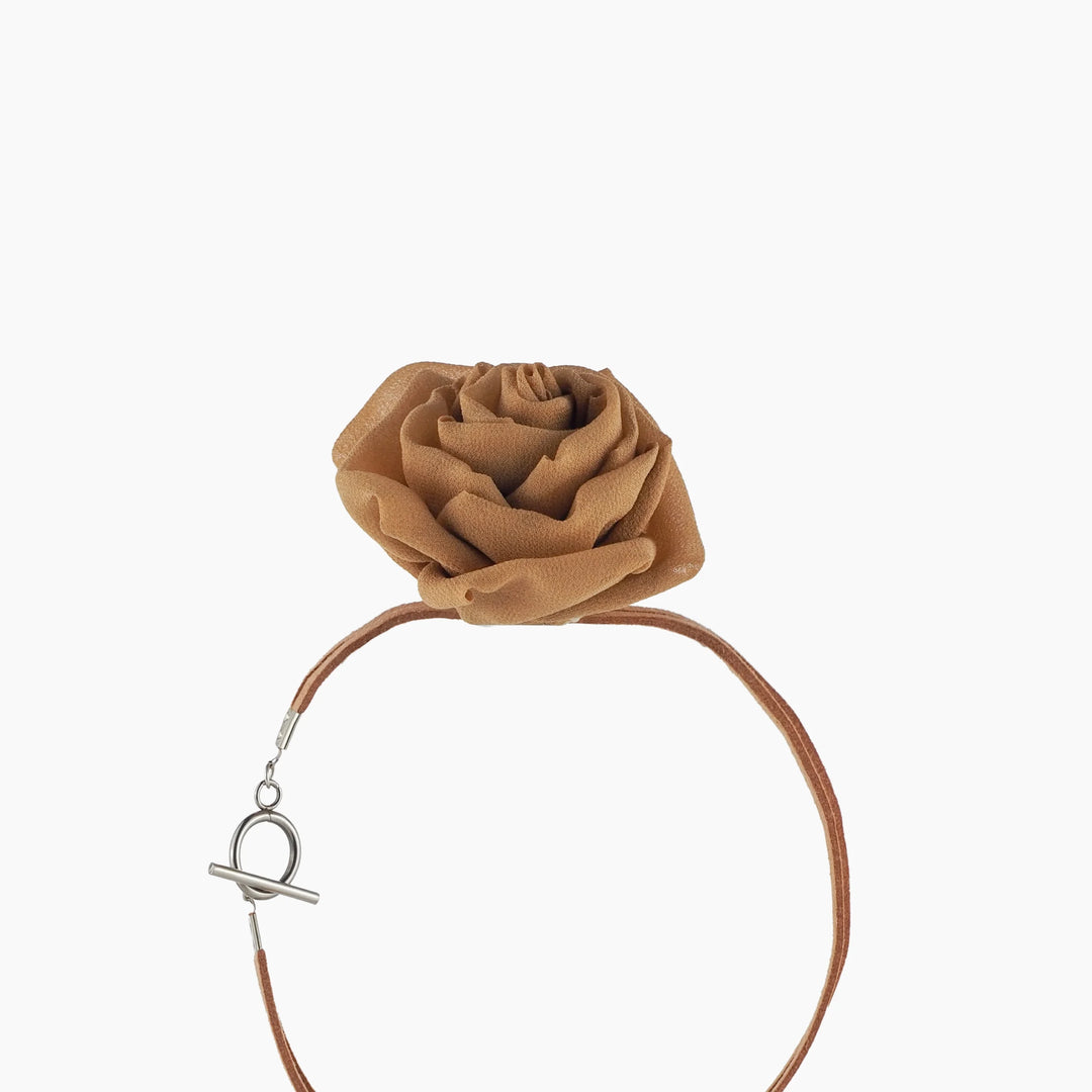 Side angle of gold silk rose choker showing layered rose petals and suede lace in circular position