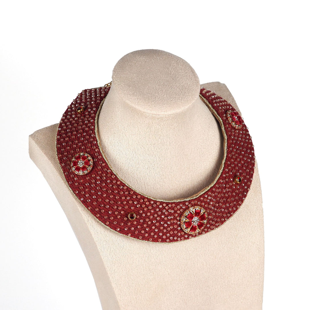 Handmade red collar necklace with gold details and circular motifs, displayed on a mannequin bust, heritage-inspired boho jewellery.