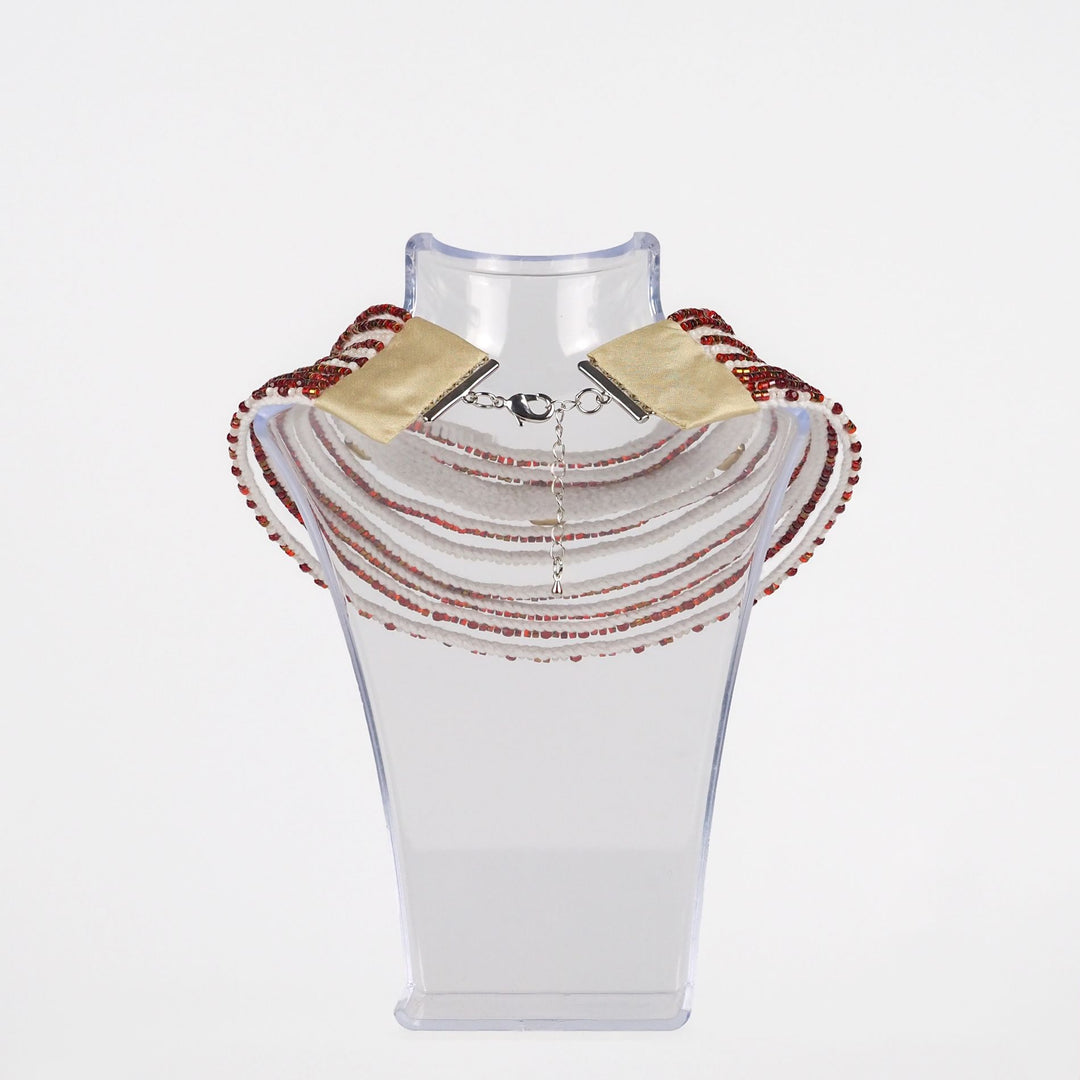 Back view of handmade red and white multi-strand necklace showing metal lobster clasp with adjustable chain, glass and mother of pearl beads on cotton cord base