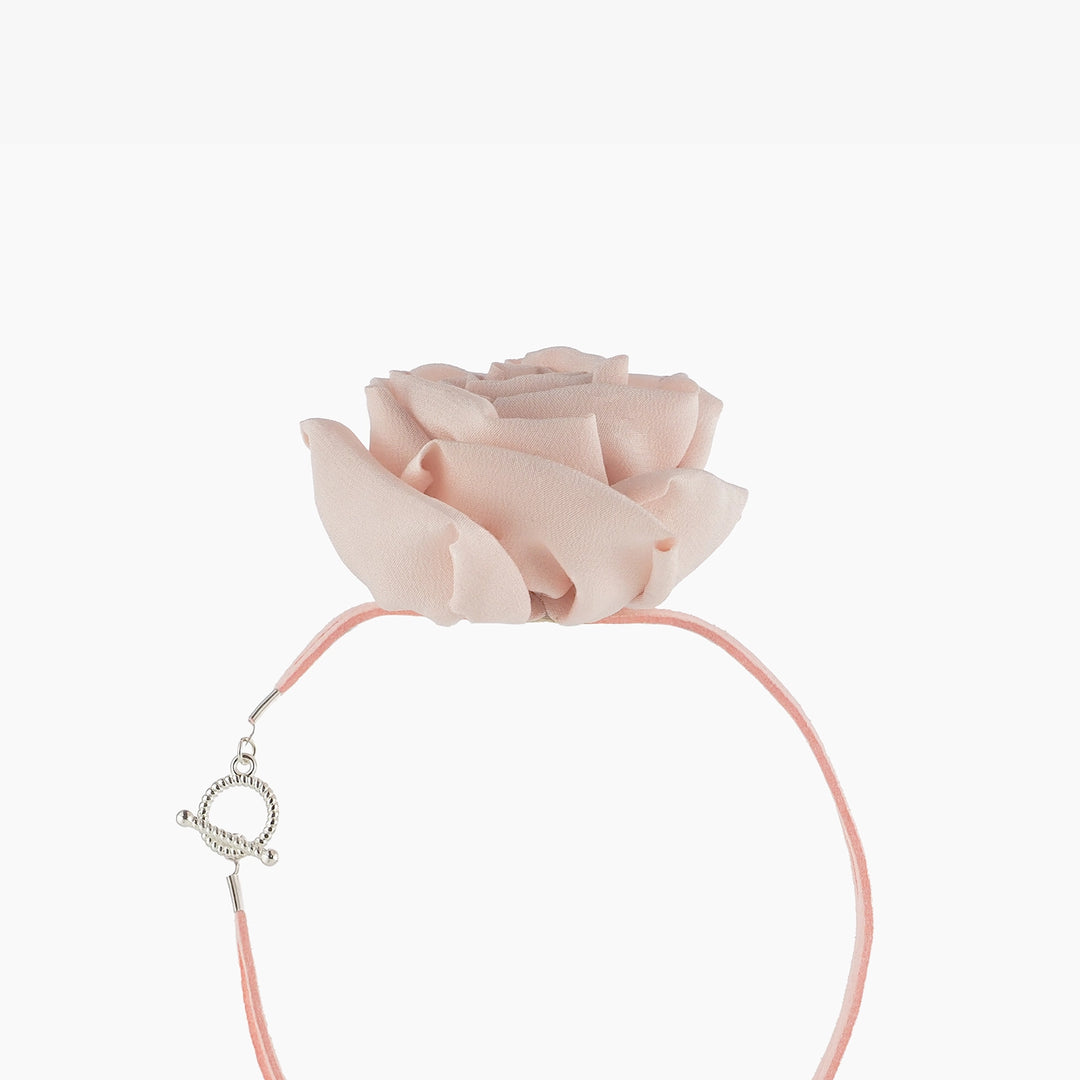 Side view of pink silk rose choker necklace showing sculptural details of the chiffon flower and suede lace with toggle clasp