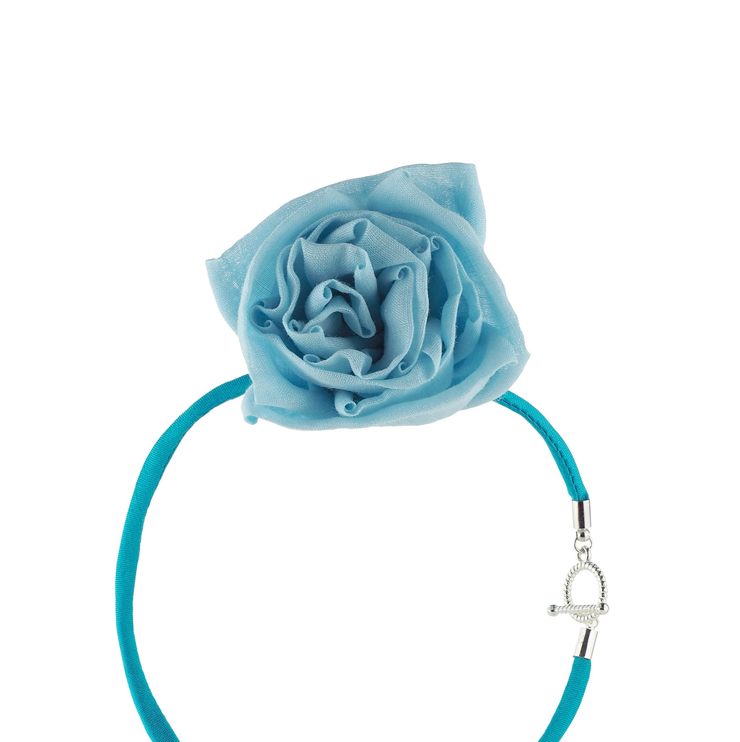 Close-up of blue silk linen rose choker necklace with detachable rose and toggle clasp