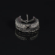 Handmade black and silver beaded bracelet with multi-strand design on textile base, featuring glass beads and rhinestone detail.
