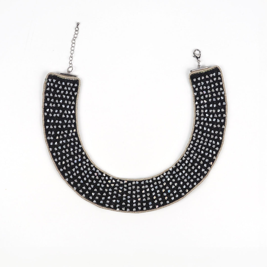 Handmade black collar necklace with pearl-tone angular beads set on black cotton cords, outlined with antique metallic thread, shown laid flat with adjustable clasp.
