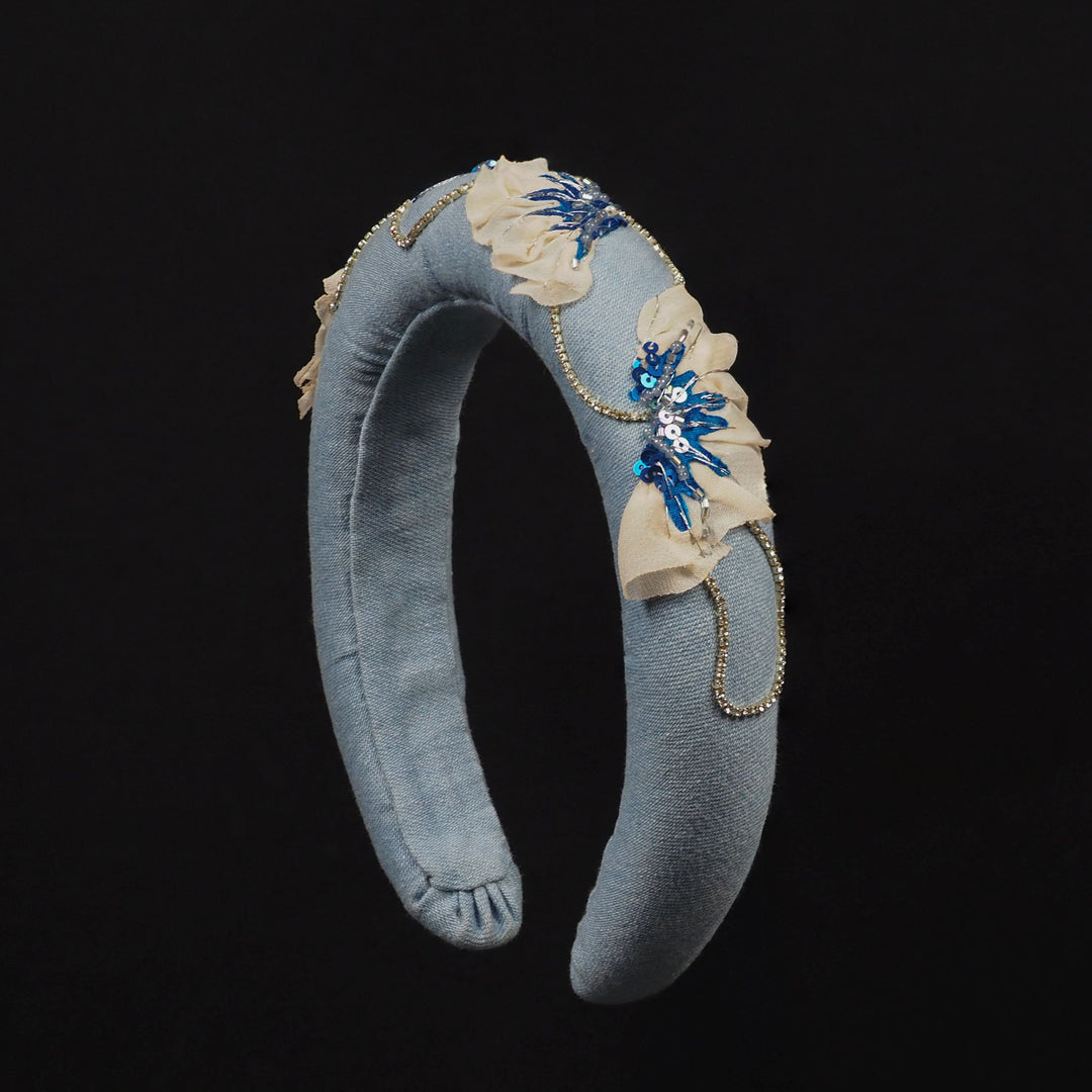 One-of-a-kind blue denim headband featuring a hand-stitched poppy motif in chiffon, sequins, beads, and rhinestone chain, made in the UK