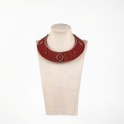 Full front display of handmade red collar necklace with beadwork and gold circular designs, heritage craft reimagined as boho jewellery.