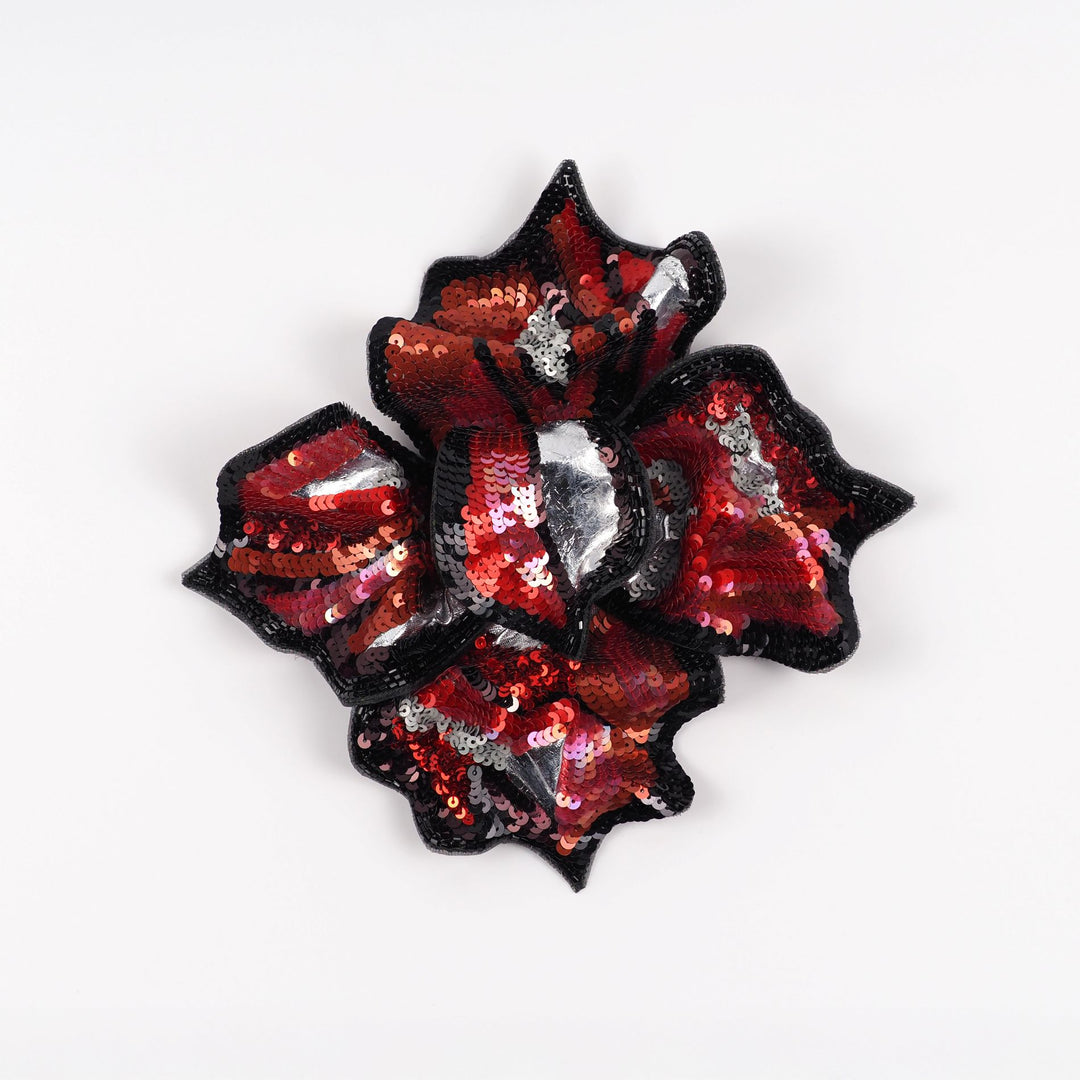 Front view of red and black hand-embroidered floral brooch by Ksenia Semirova, featuring sequins, beads, and silver details on silk organza