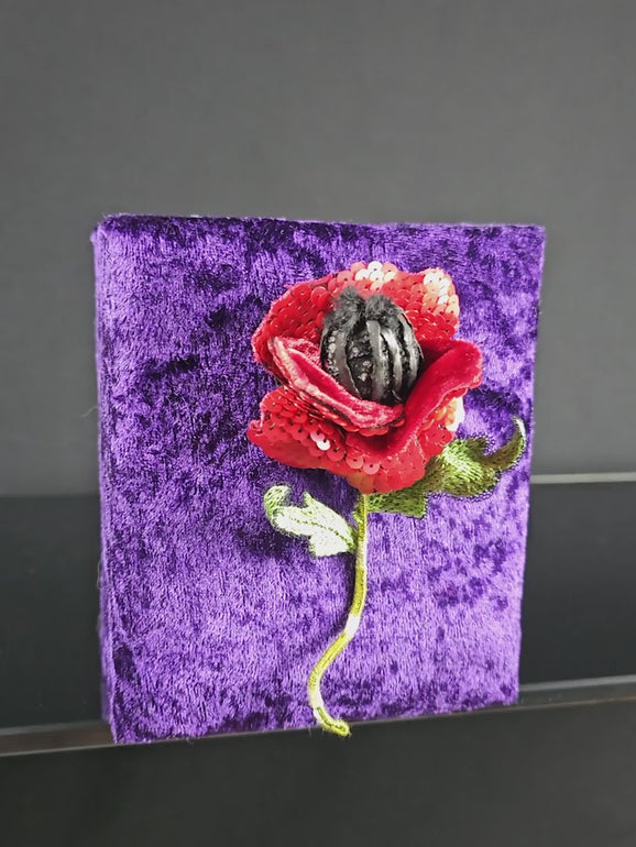 Short video showing the red poppy brooch in motion. Highlights the 3D structure, sequin petals, and embroidered details from multiple angles